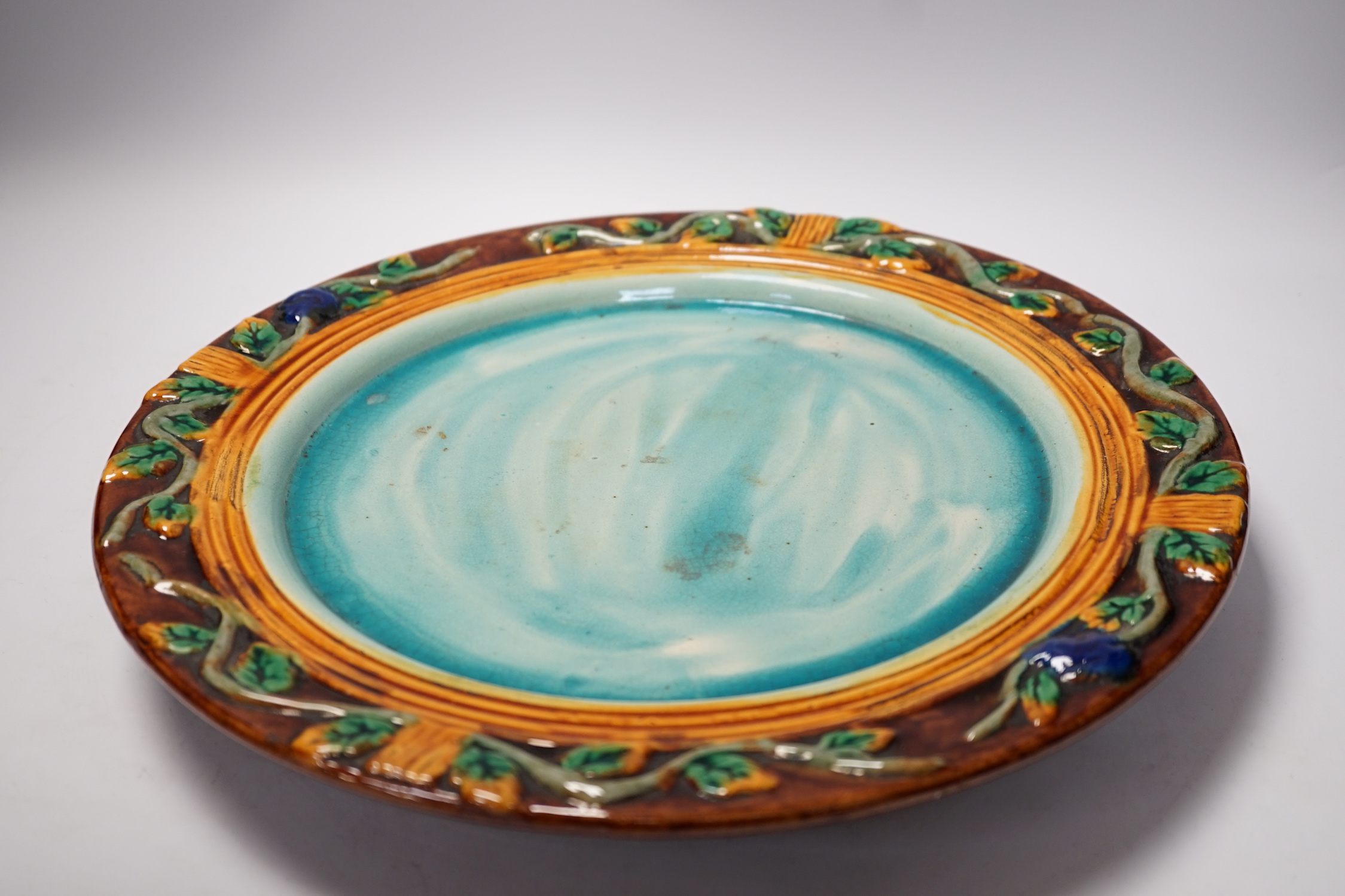 A Minton style Majolica cheese dish and cover decorated in relief, restored handle, 35cm